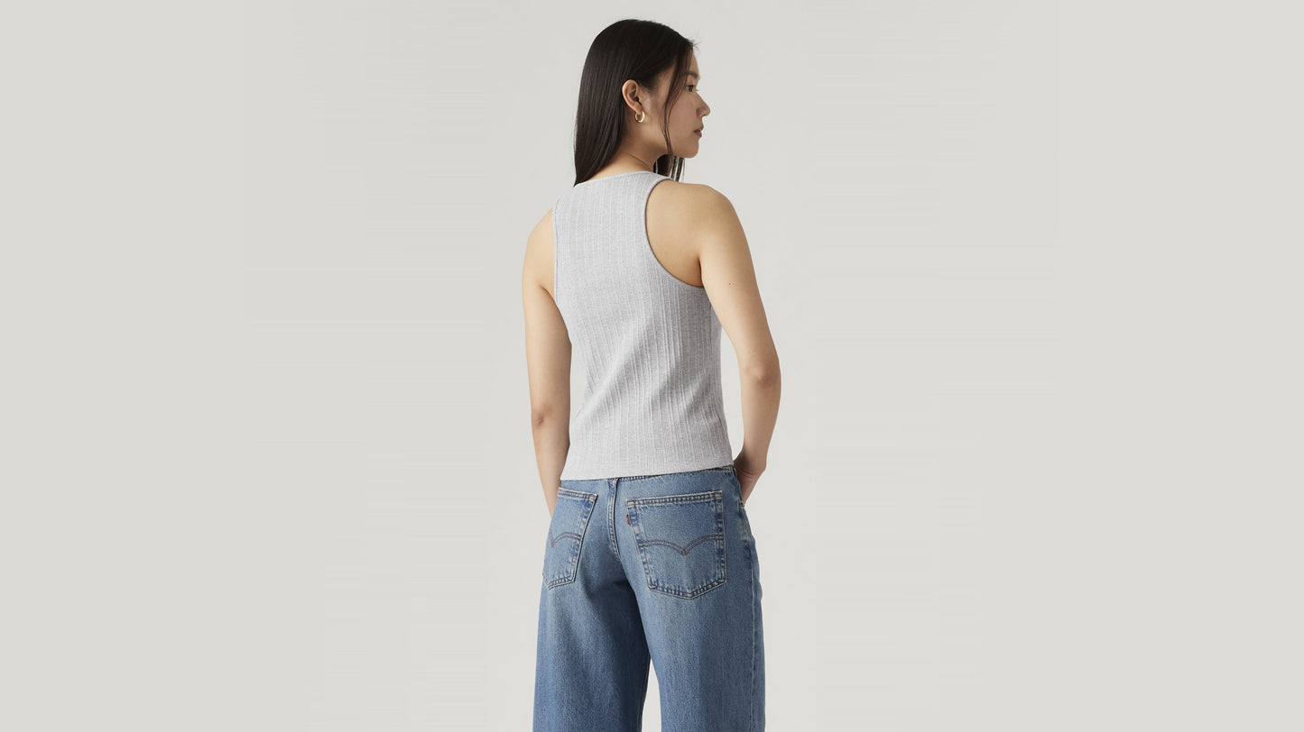 Rear view of woman in ribbed grey tank and blue denim