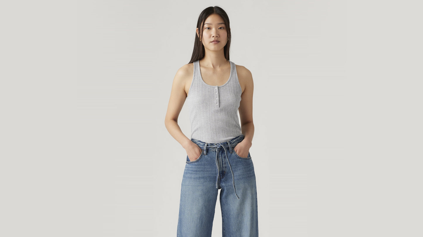 Woman wearing grey tank and relaxed tie-waist jeans