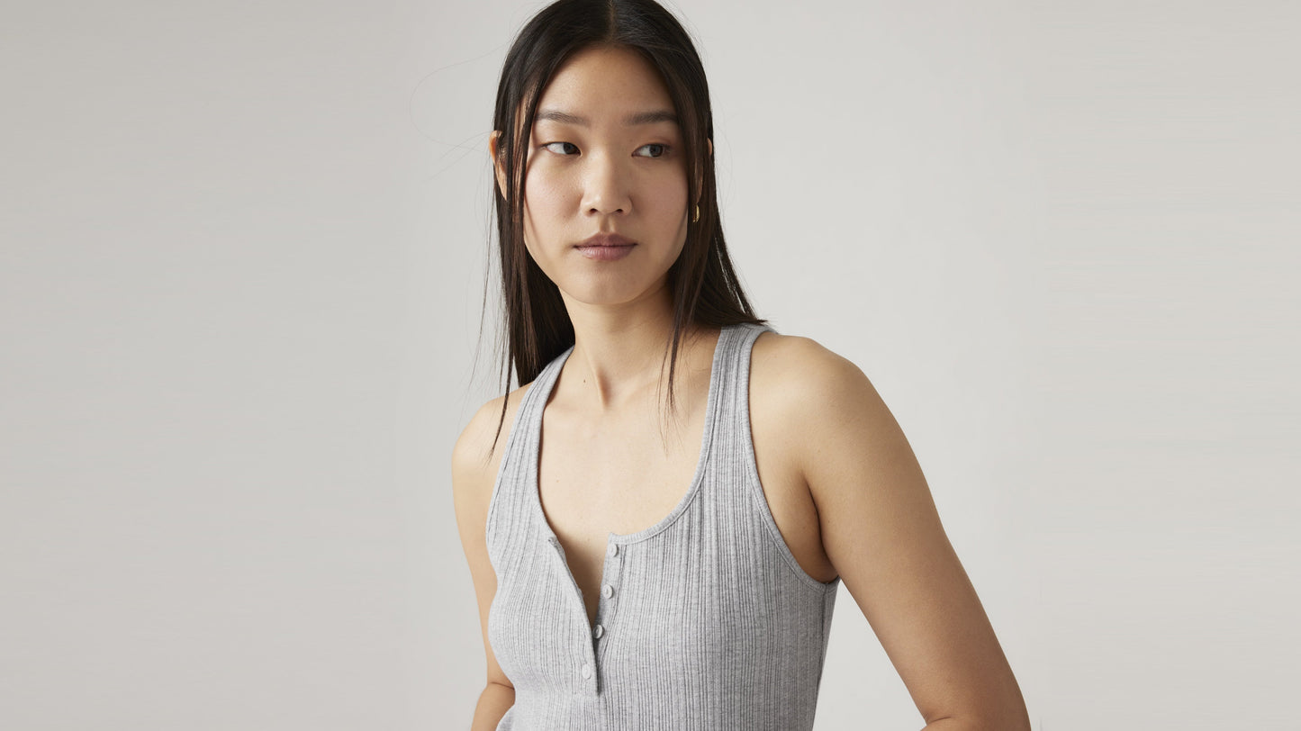 Woman in grey ribbed tank looking to the side