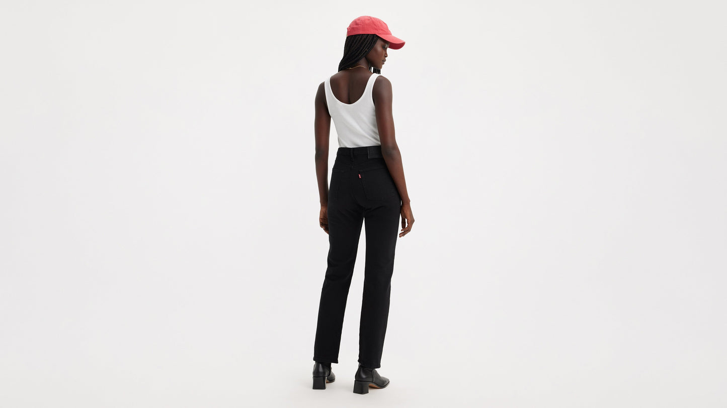 Rear view of woman wearing black Wedgie Straight jeans and boots