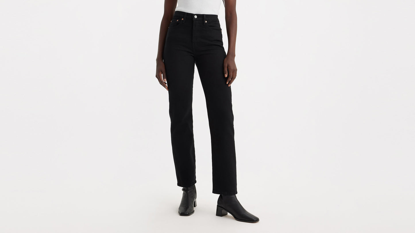 Front view of black Wedgie Straight jeans paired with black boots