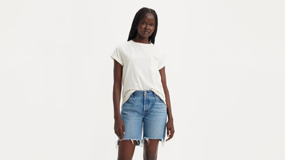 Woman in Levi's white pocket shirt and denim shorts