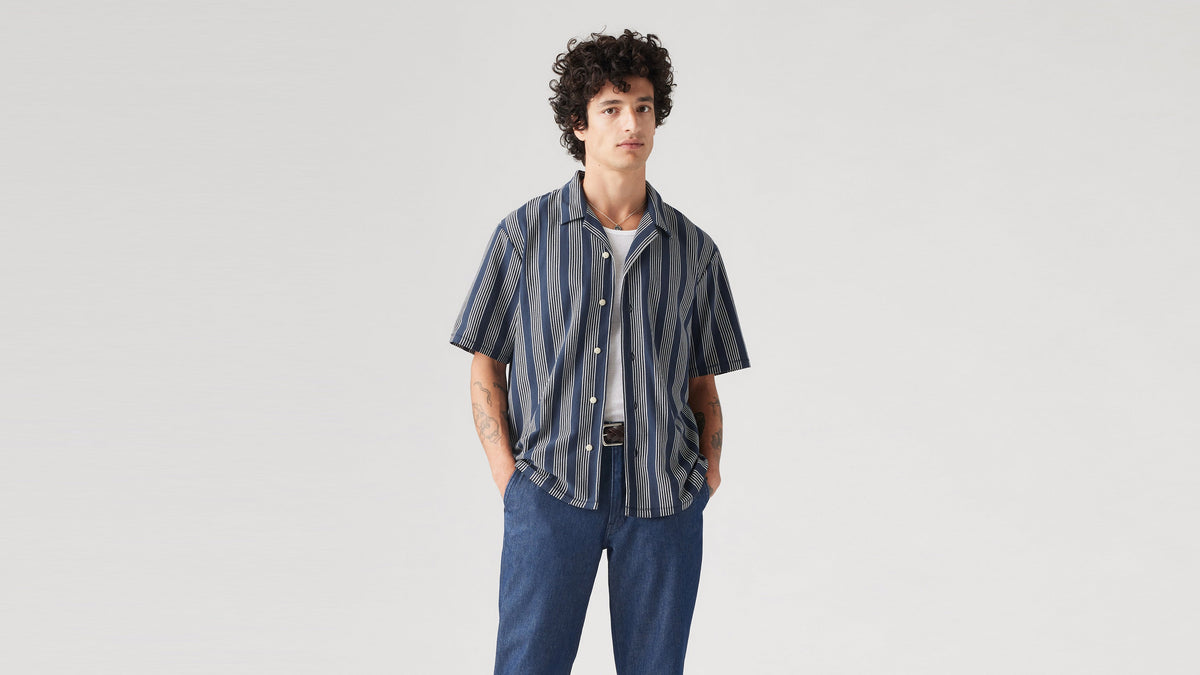 Man in blue striped Levi's men's knit camp shirt front view