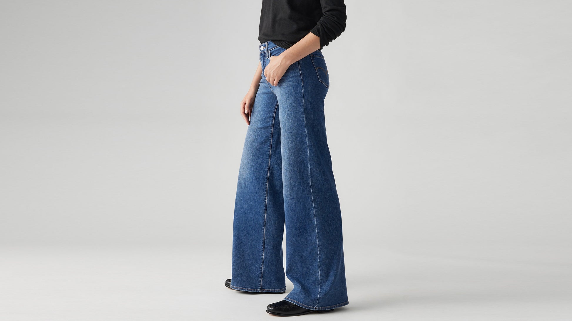 Model wearing Levi's women's jeans, close-up side view