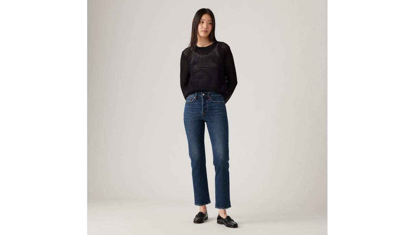 Woman in Levi's black mesh sweater and blue jeans