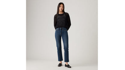 Woman in Levi's black mesh sweater and blue jeans