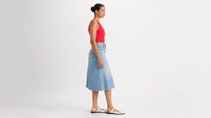 Woman in Levi's high-rise a-line skirt and red top side view