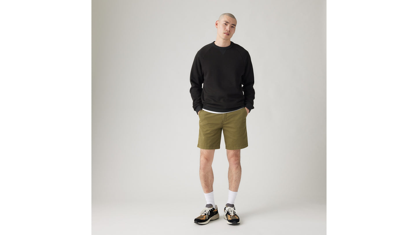Man wearing olive Levi's shorts and black sweatshirt