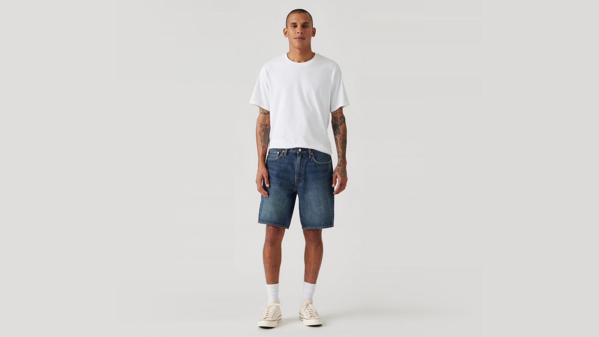Man wears Levi's denim shorts and white shirts