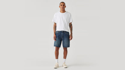 Man wears Levi's denim shorts and white shirts