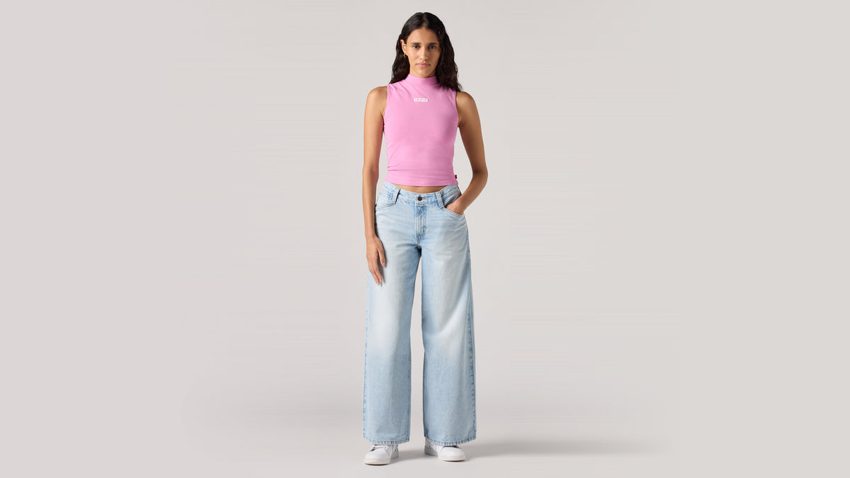 Woman in Levi's light-blue wide-leg jeans and pink top