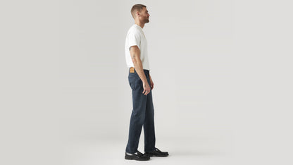 Side view of a man in dark wash straight-leg Levi’s jeans and a white tee