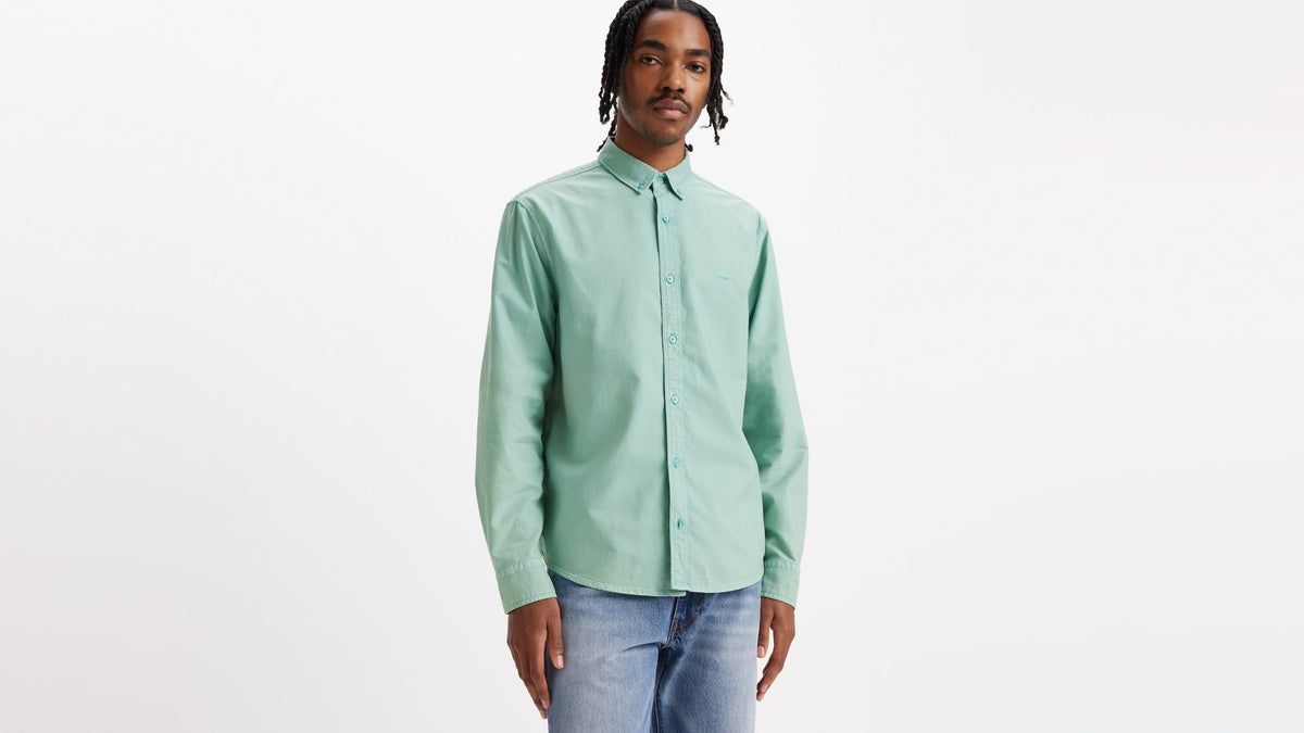 Man in mint green button-down shirt and jeans
