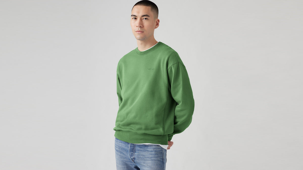 Man in green Levi's sweatshirt and blue jeans