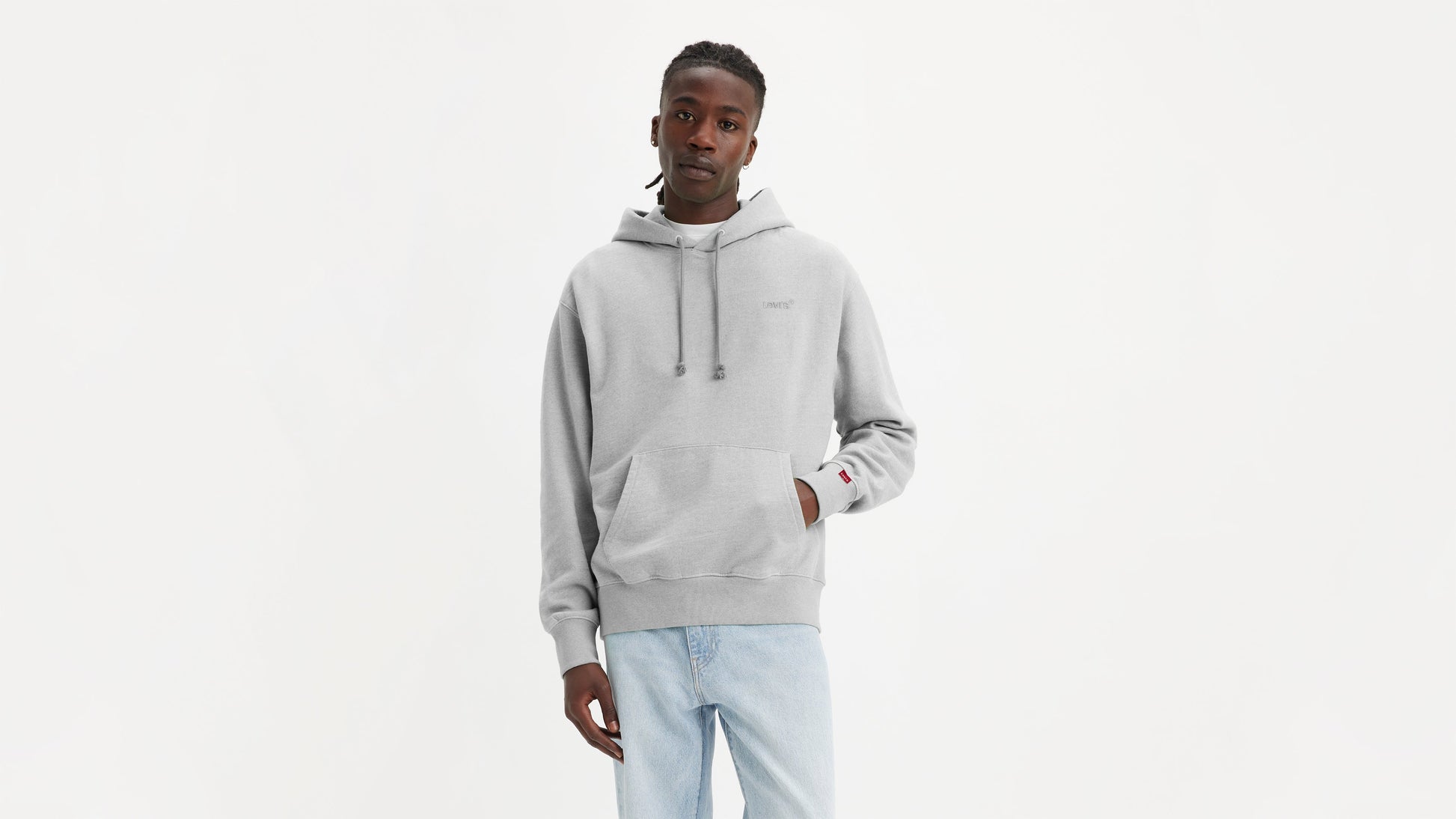 Man in grey Levi's Men's Authentic Hoodie with light wash jeans facing forward