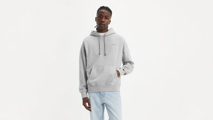 Man in grey Levi's Men's Authentic Hoodie with light wash jeans facing forward