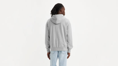 Man in grey Levi's Men's Authentic Hoodie with light wash jeans facing backward