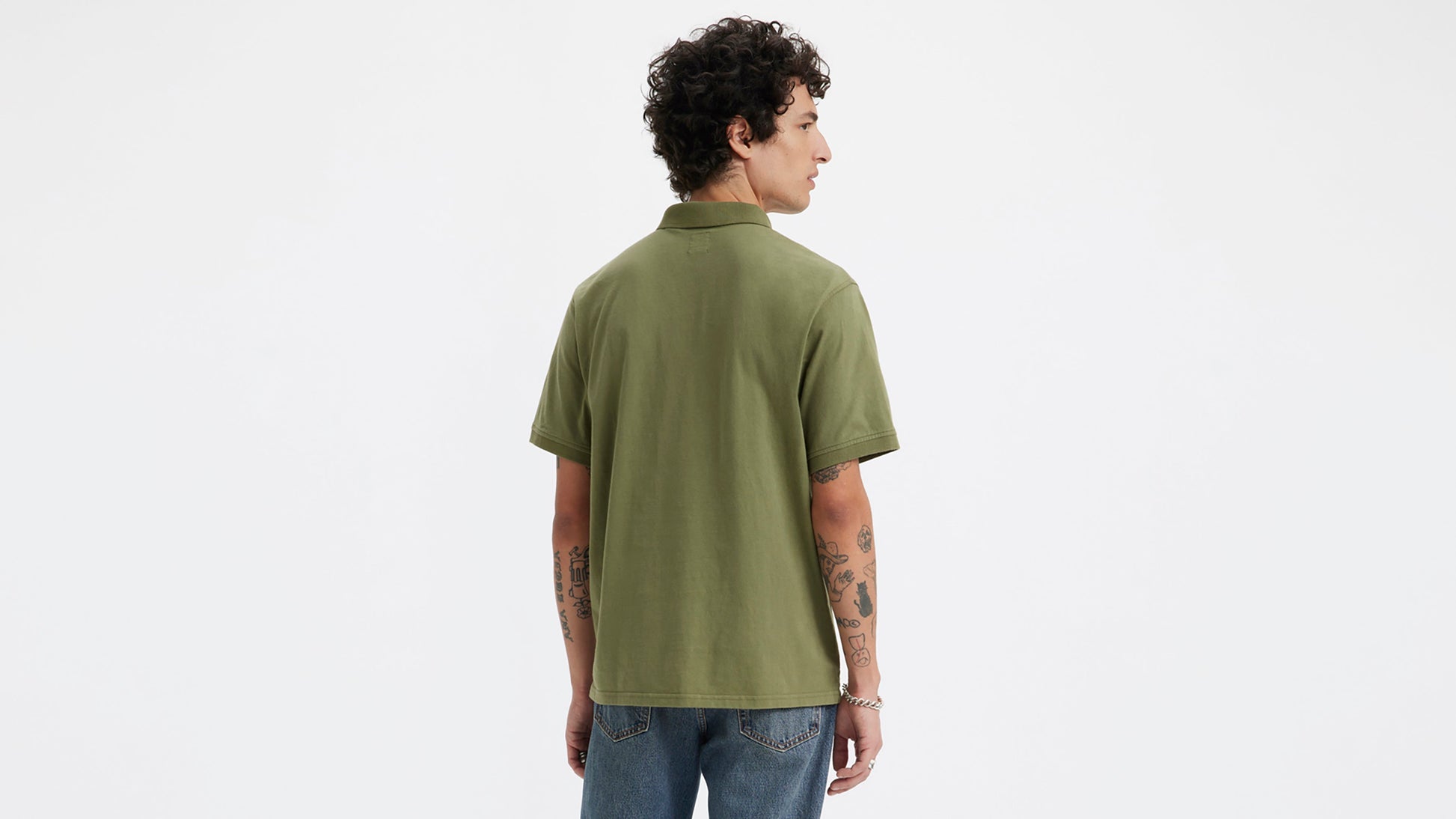 Back view of man in olive green Levi's polo and jeans