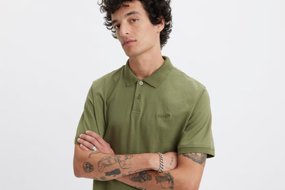 Close-up of model wearing green Levi's polo shirt
