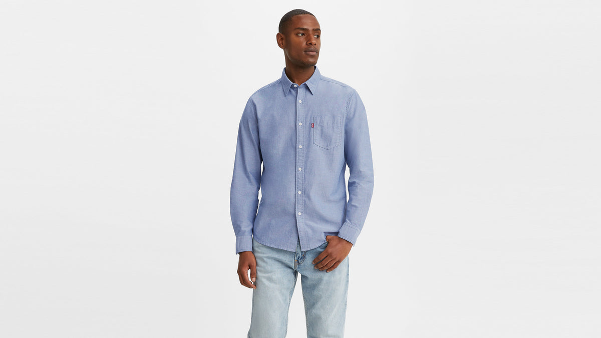 Front view of a man in a light blue Men's Classic Pocket & light blue jeans