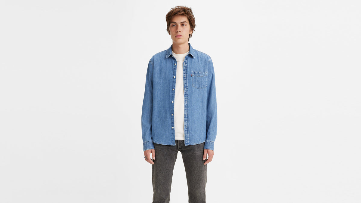 Front view of a man in a Levi’s light blue Men's Classic shirt & grey jeans