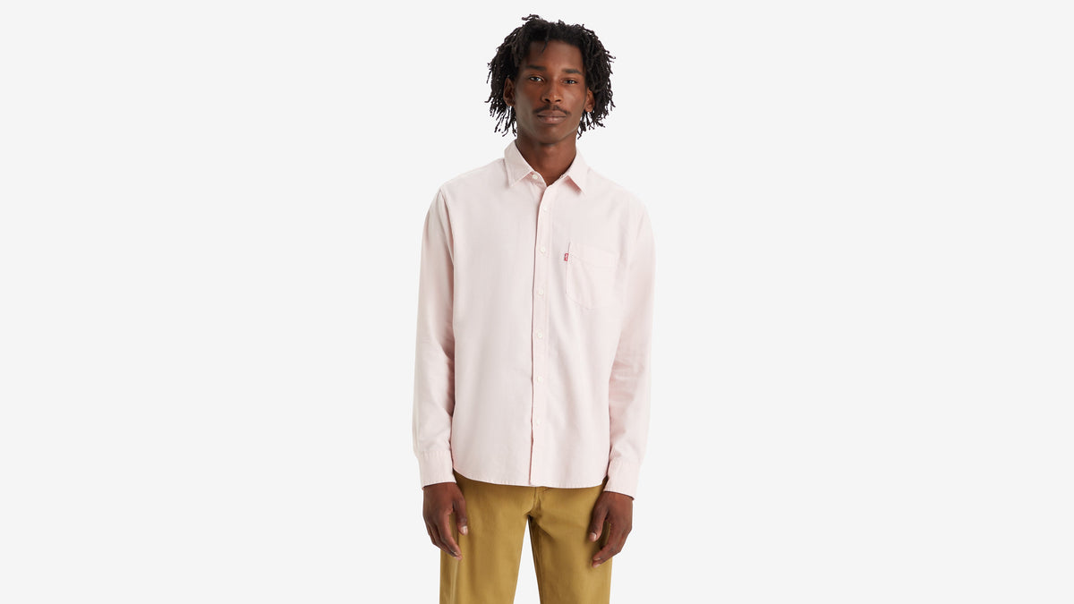 Front view of a model in a pink Levi's Men's Classic Pocket Shirt paired with mustard yellow pants