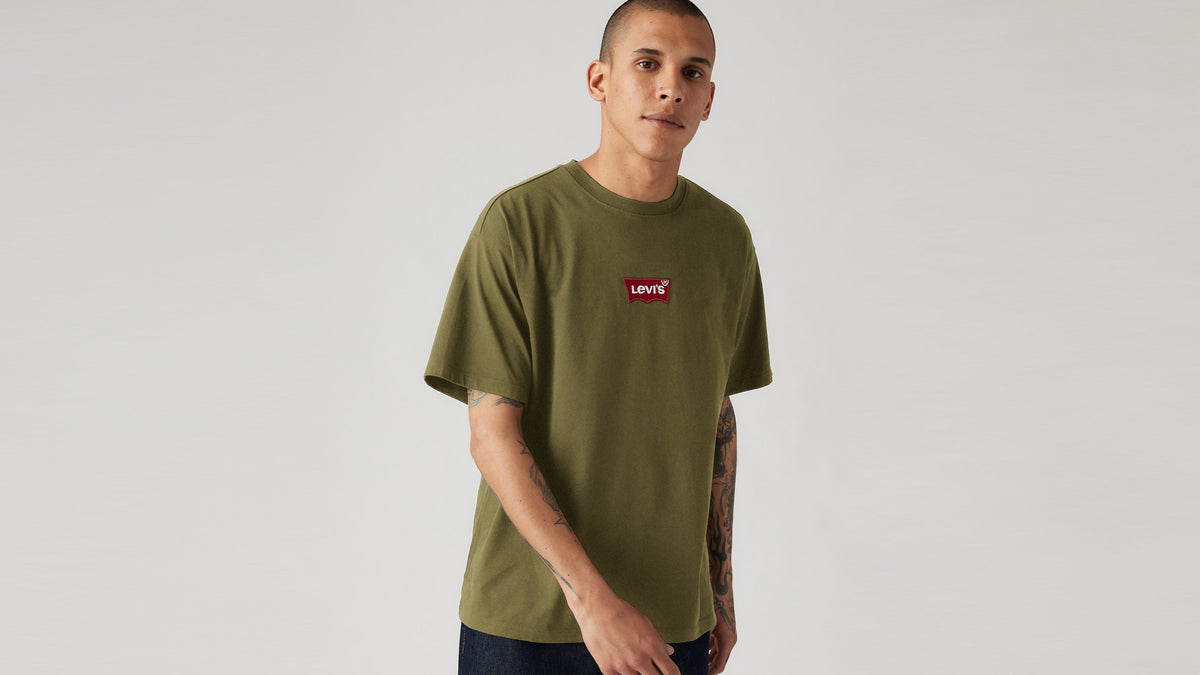 Man wearing olive green Levi’s t-shirt with red chest logo