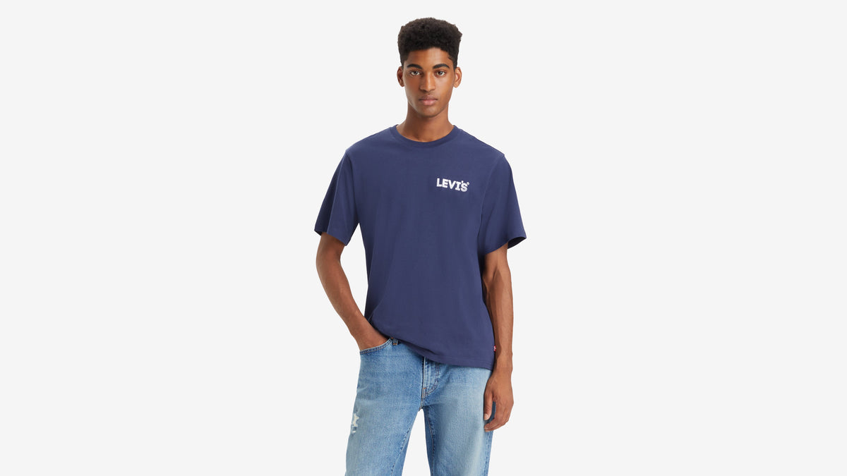 Man wearing navy Levi’s graphic tee with white logo and light blue jeans, front view