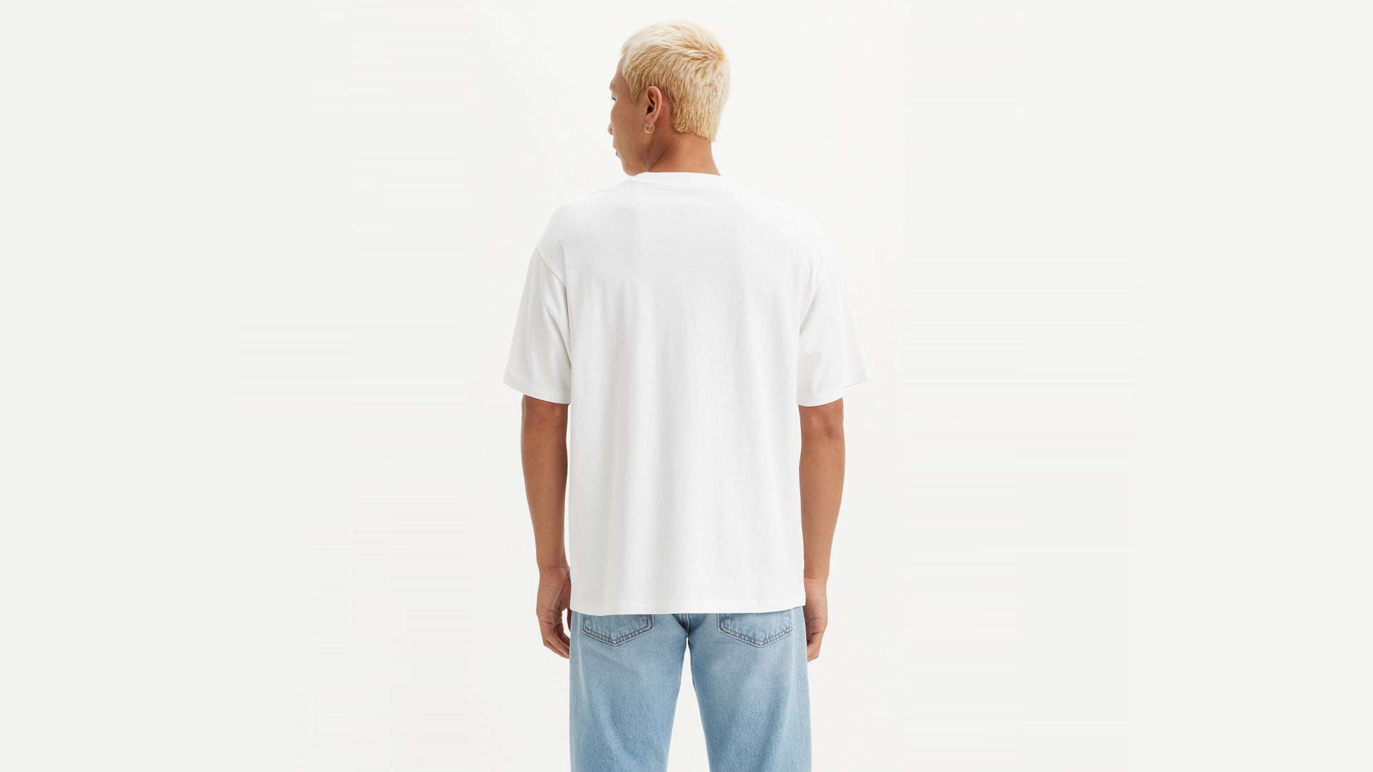 Man in Levi's White Vintage Batwing Graphic T-Shirt with light jeans, back view