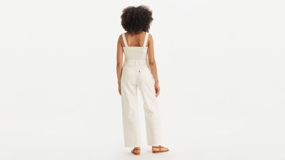 Back view of woman in white Levi’s jumpsuit