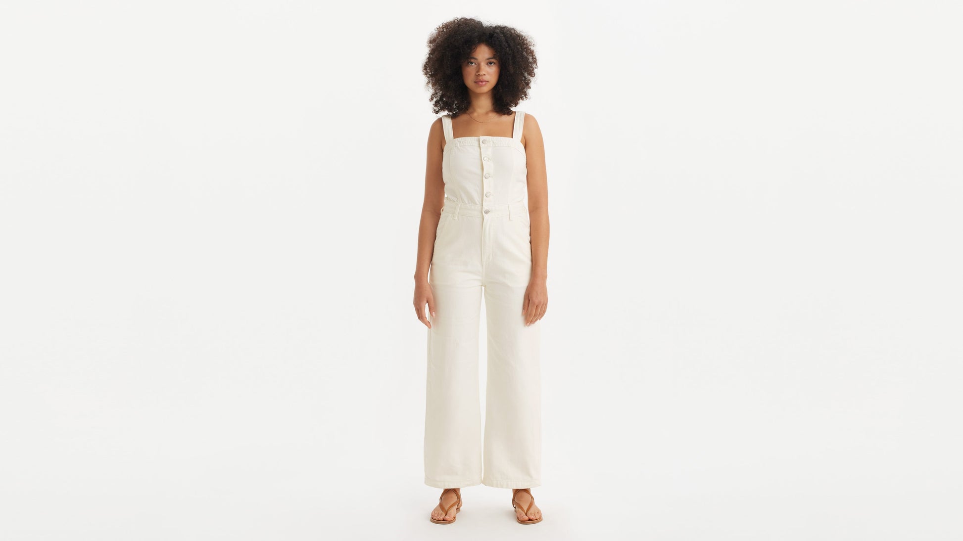 Model wearing wide-leg ivory denim jumpsuit