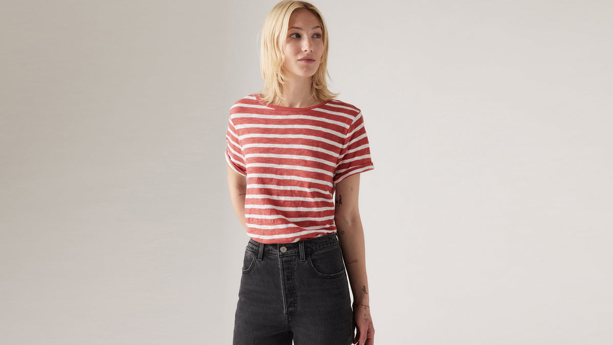 Woman in red and white striped Levi's tee and black jeans