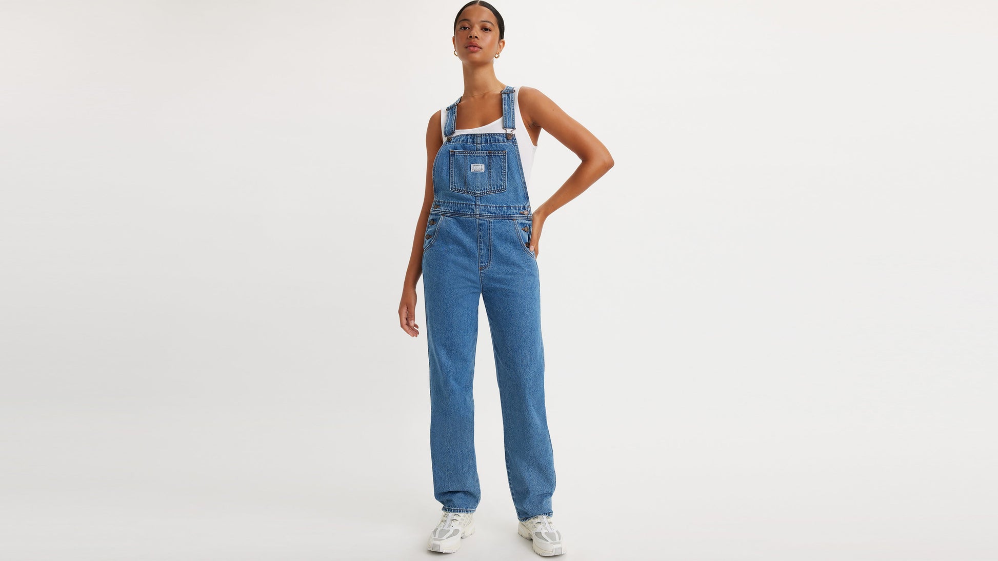 Woman in Levi’s vintage denim overalls and white tank