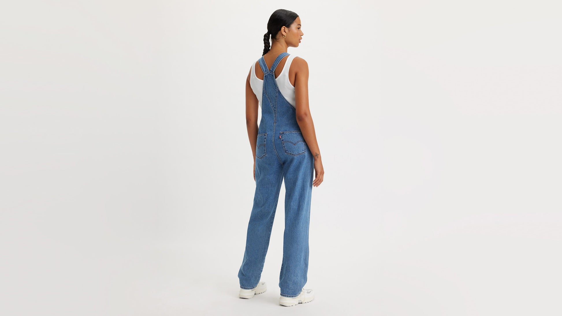 Woman in Levi’s denim overalls, back view