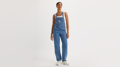Woman in Levi’s denim overalls with hands at sides