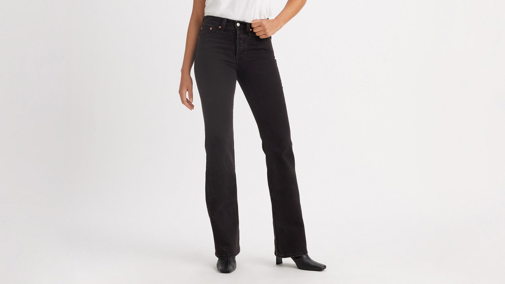 Cropped front view of a woman in black Levi's Wedgie Jeans, & boots
