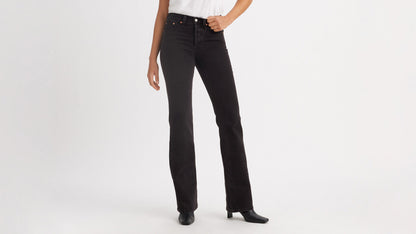 Cropped front view of a woman in black Levi's Wedgie Jeans, & boots